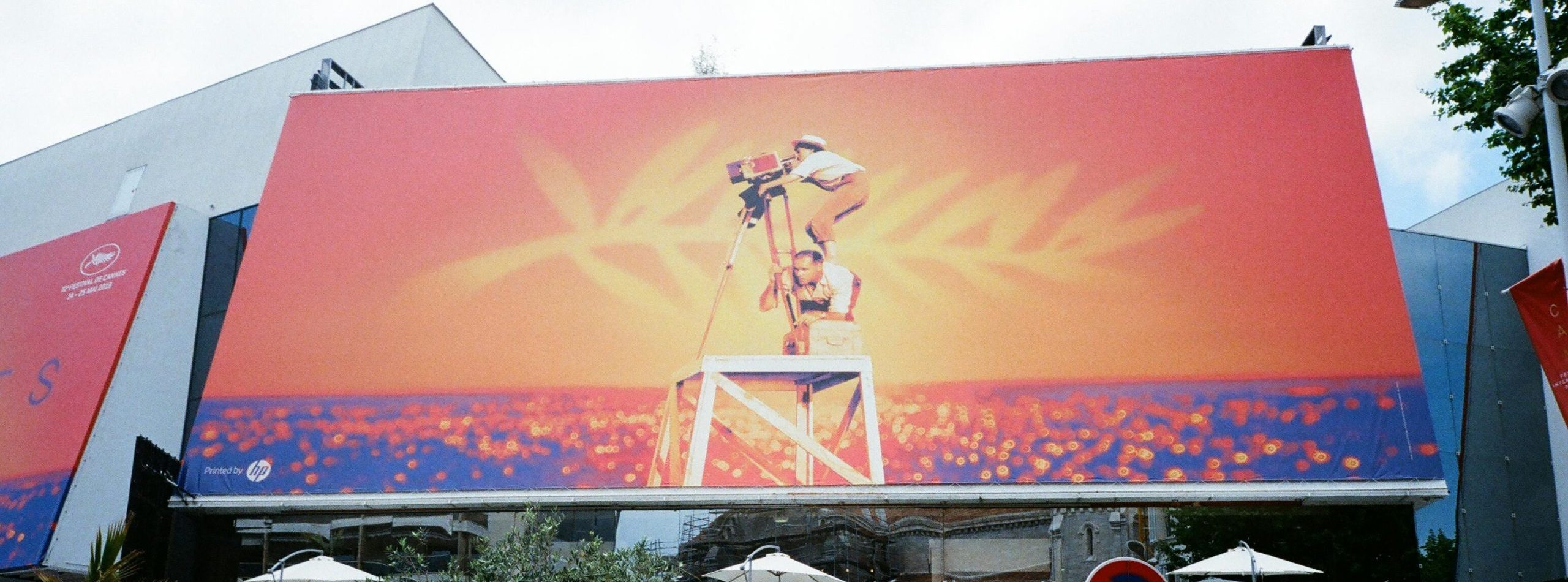 Large billboard at the Cannes Film Festival showcasing vibrant imagery.